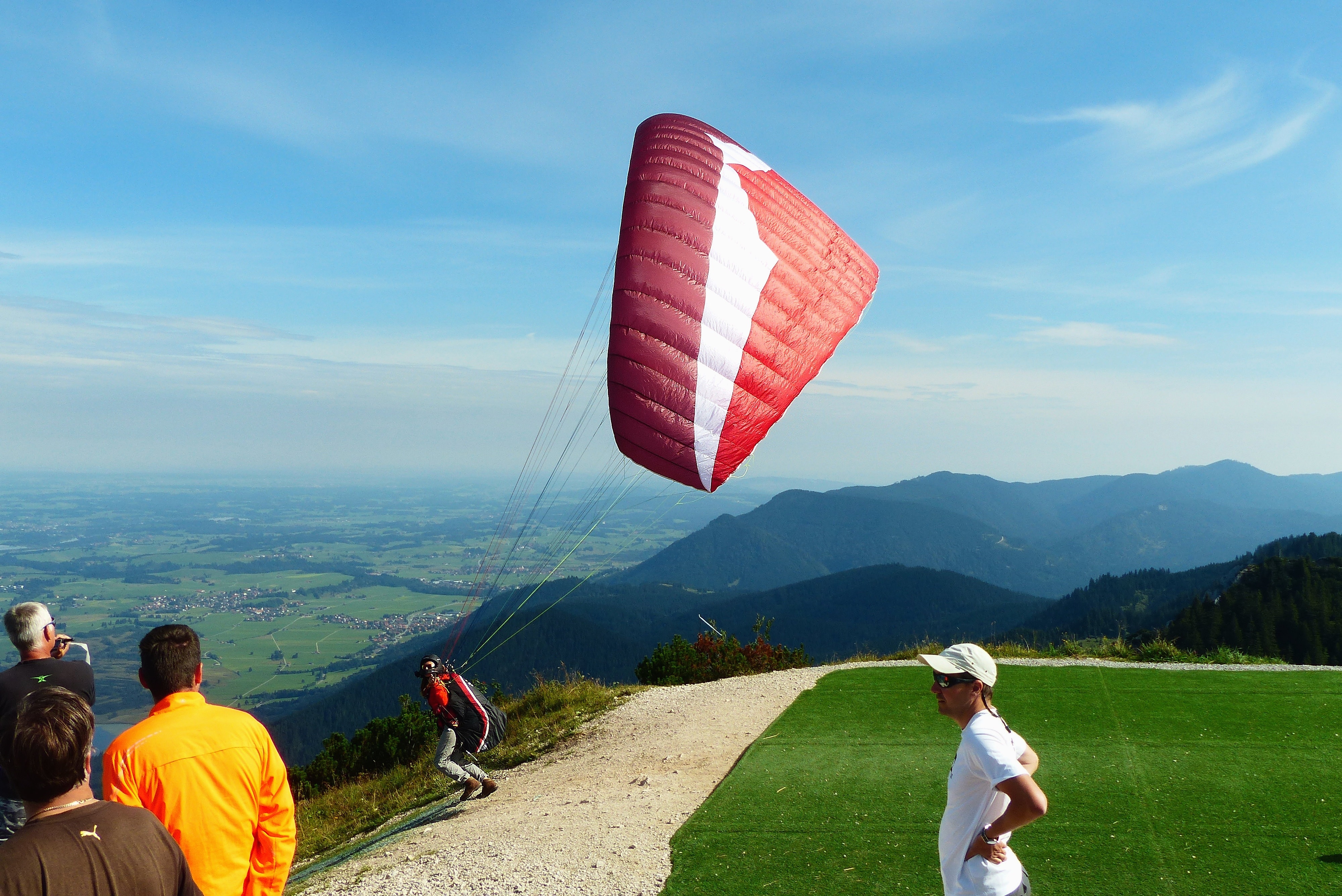 red and white paragliding