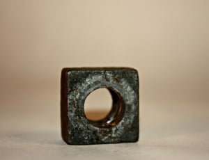 close up photography of gray metal square with hole thumbnail
