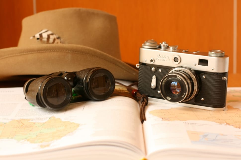black and gray milc camera black binoculars and brown cowboy hat preview