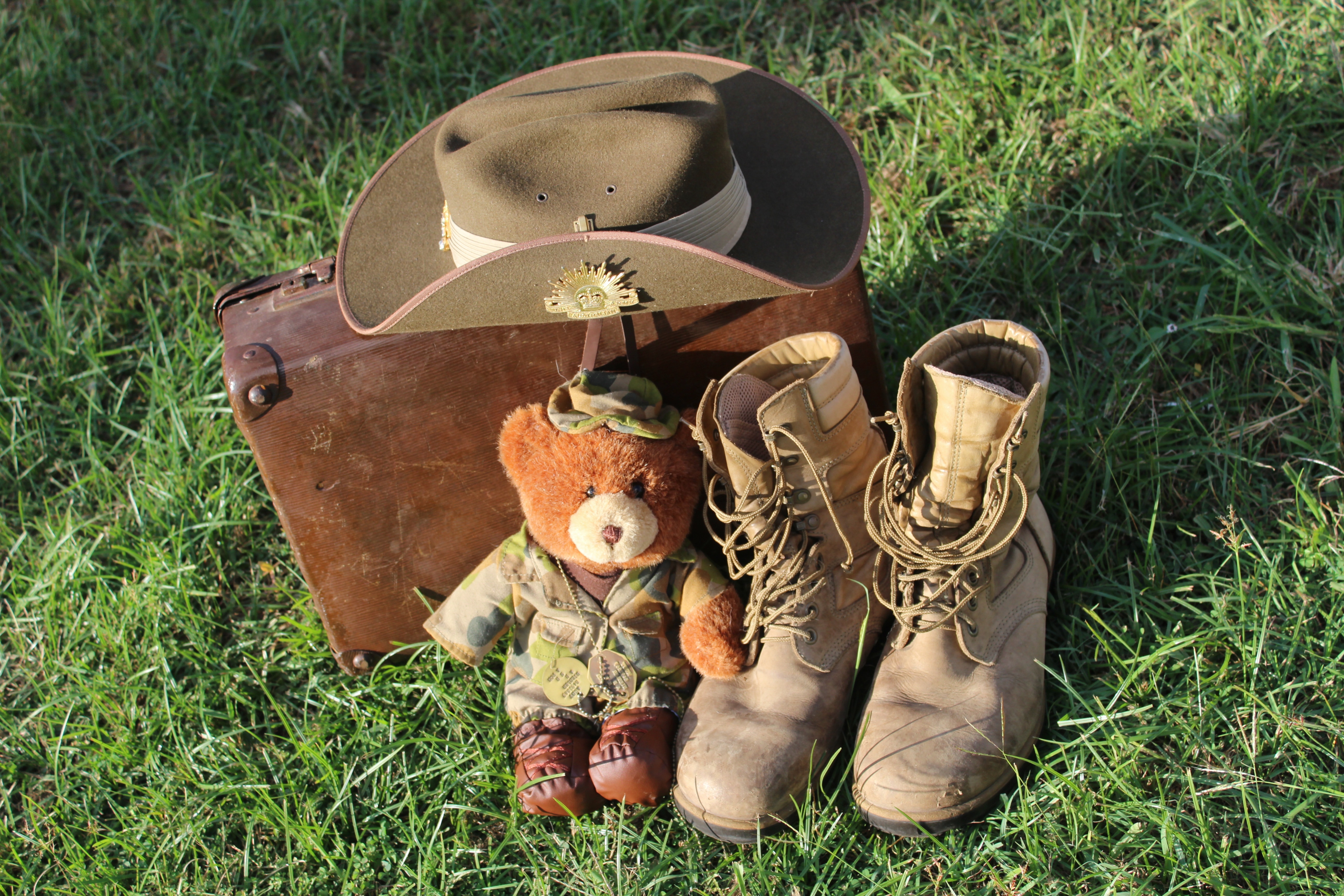 cowoby hat, boots, teddy bear and suit case