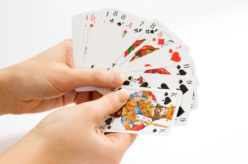 person holding playing cards preview