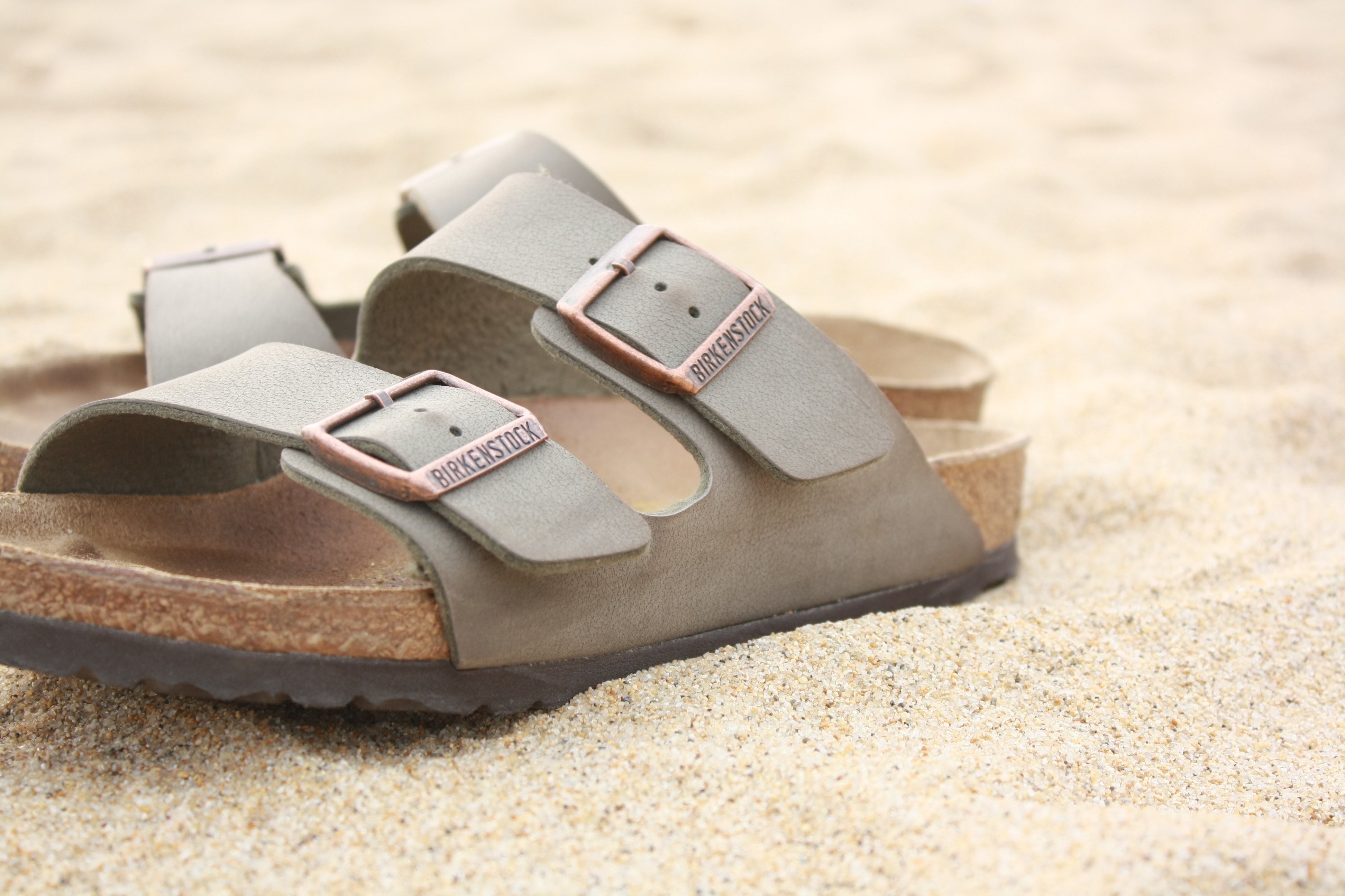 pair of gray and brown slip on sandals