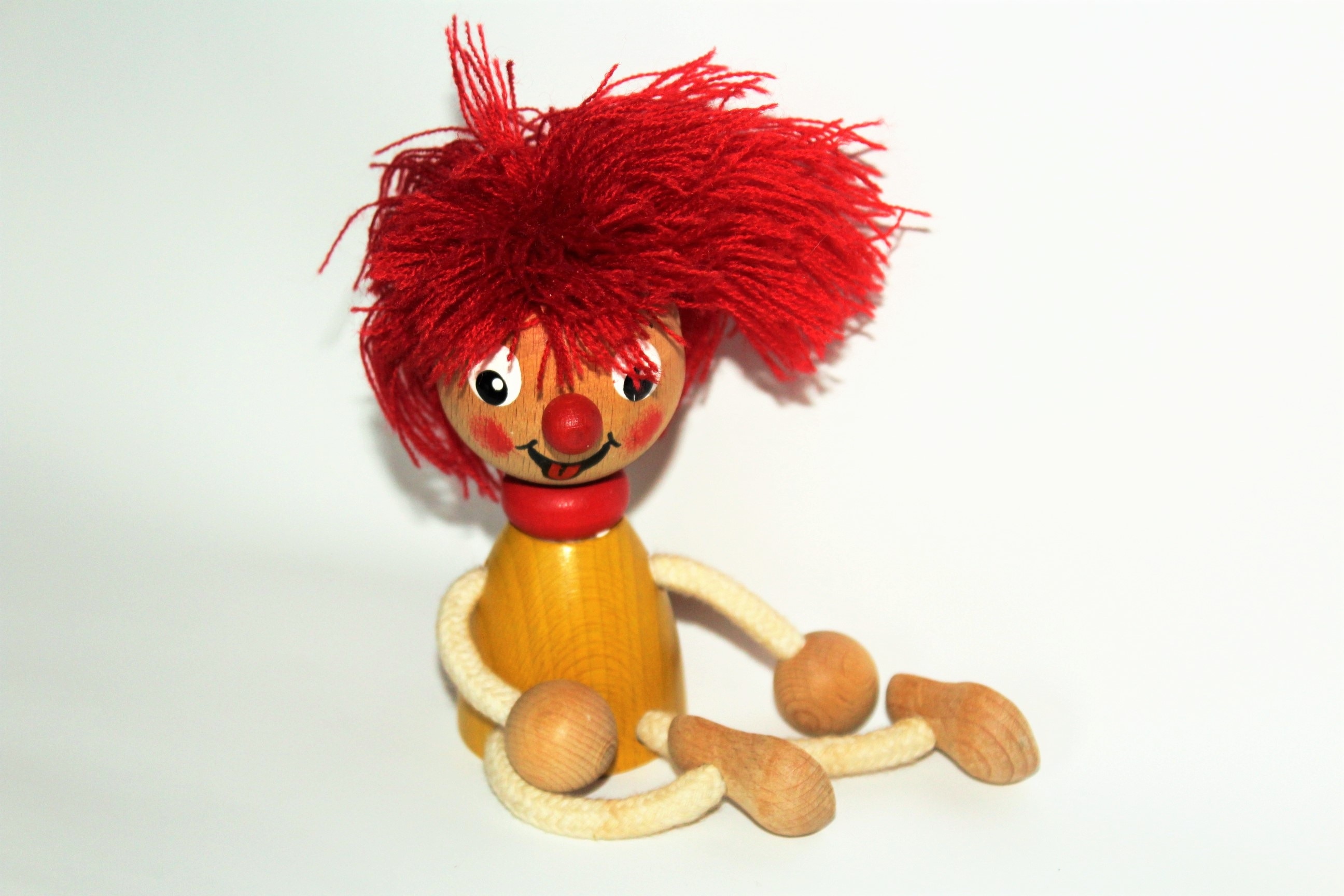 red haired wooden doll