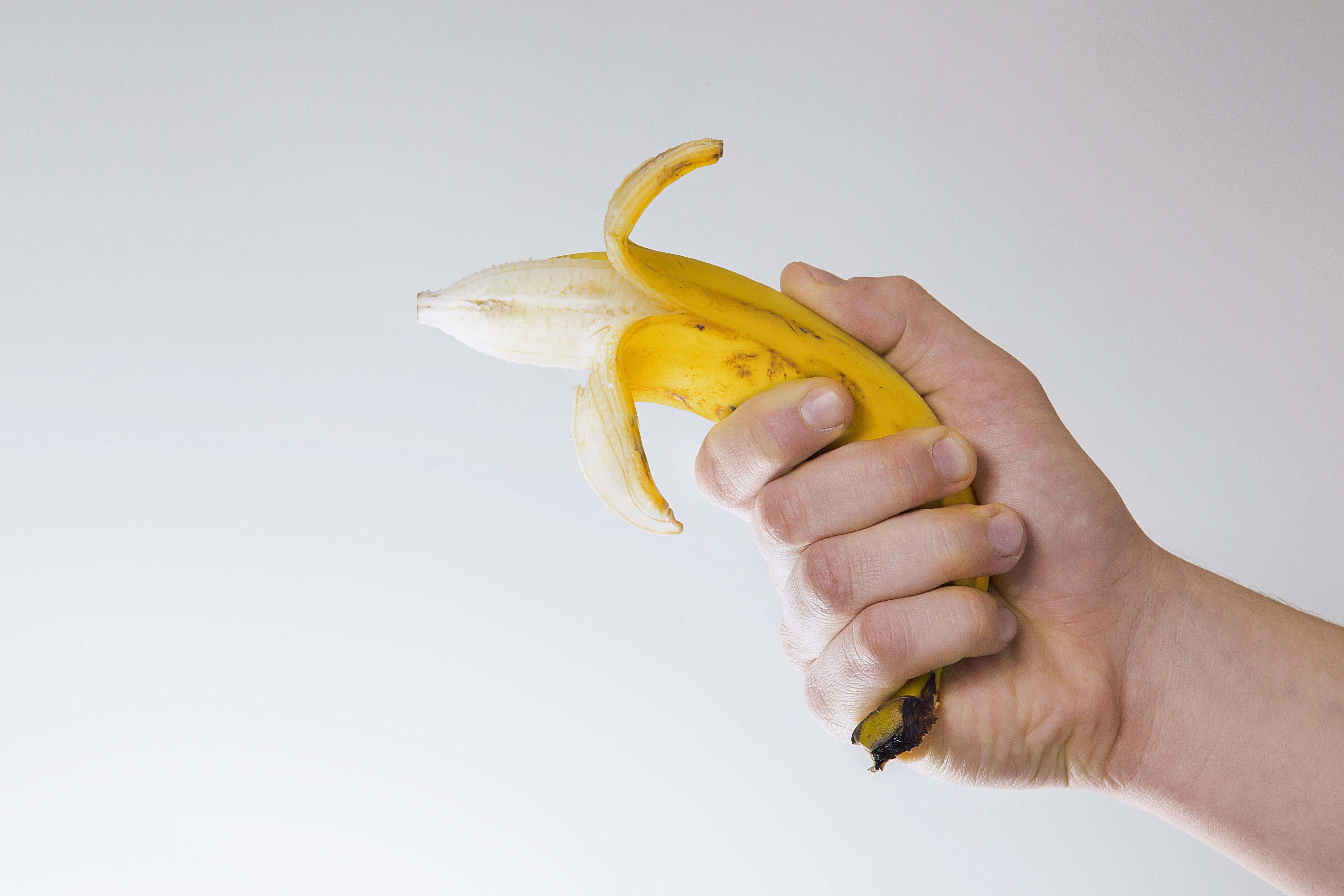 person holding yellow pilled banana