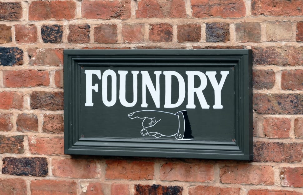 black foundry wall decor mounted on brown wall bricks preview