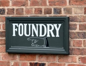 black foundry wall decor mounted on brown wall bricks thumbnail