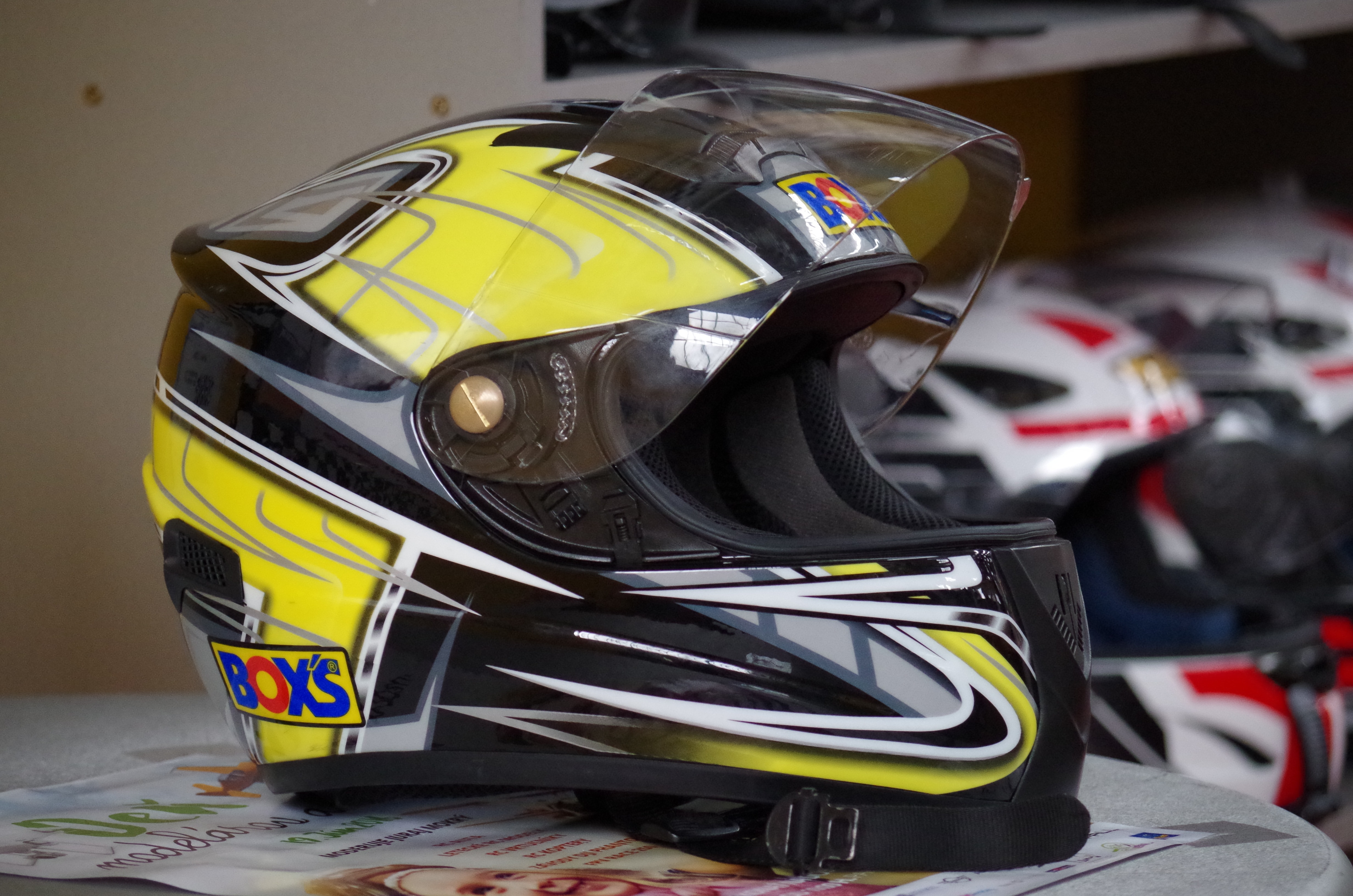 yellow white and black motorcycle helmet