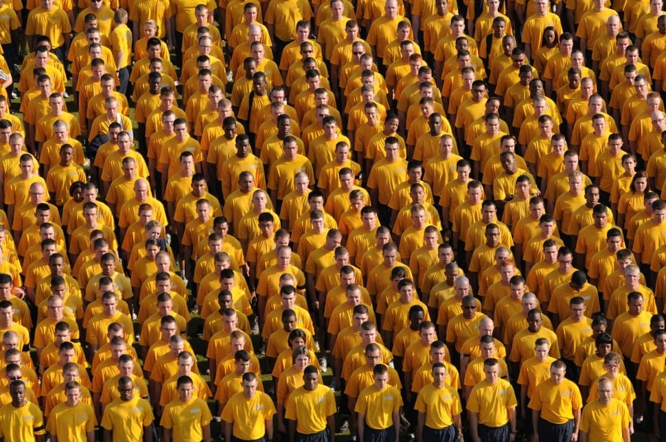 group of people wearing yellow shirt in formation preview