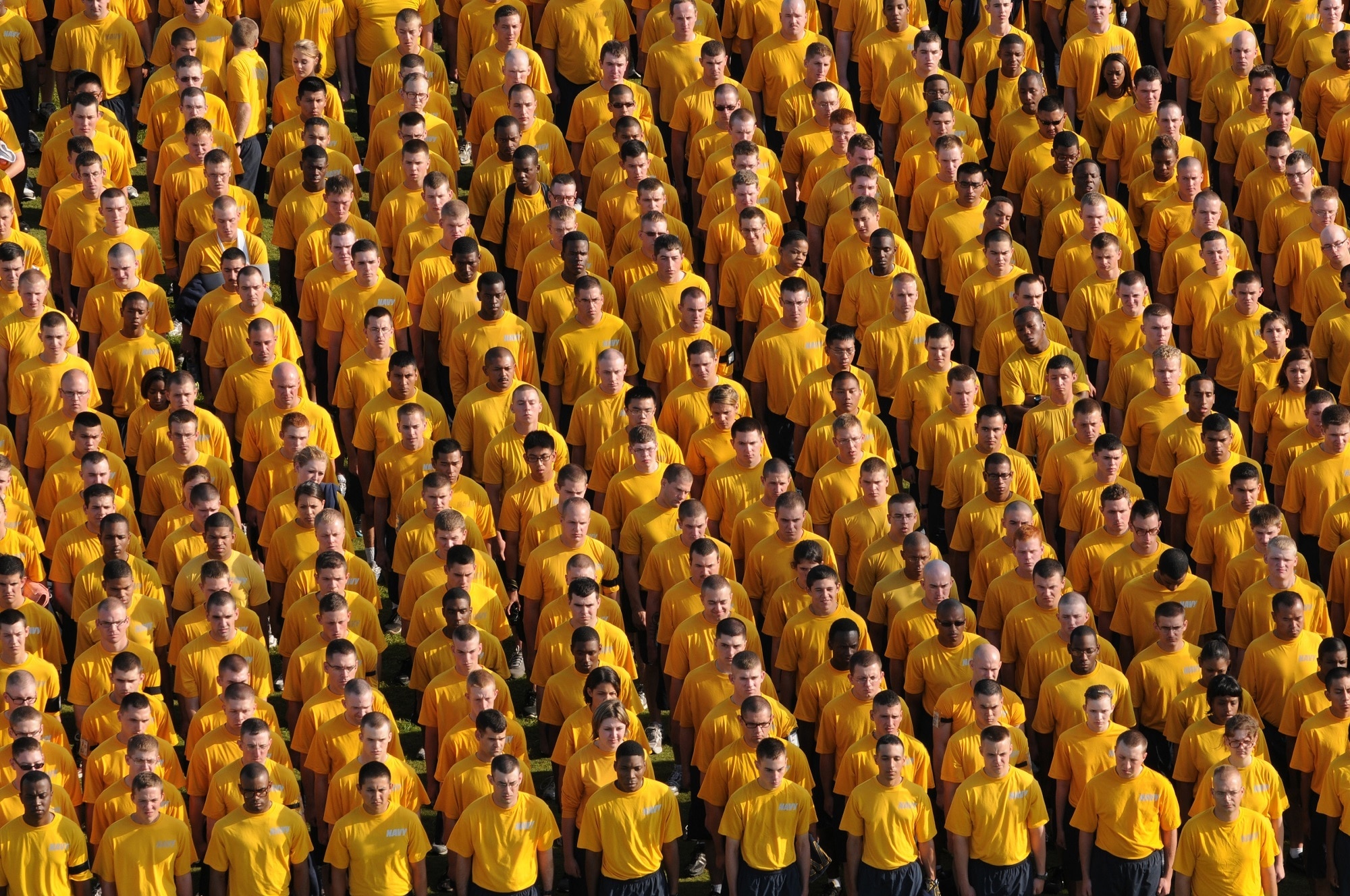 group of people wearing yellow shirt in formation
