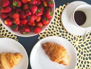 strawberries and two crossiants on table thumbnail
