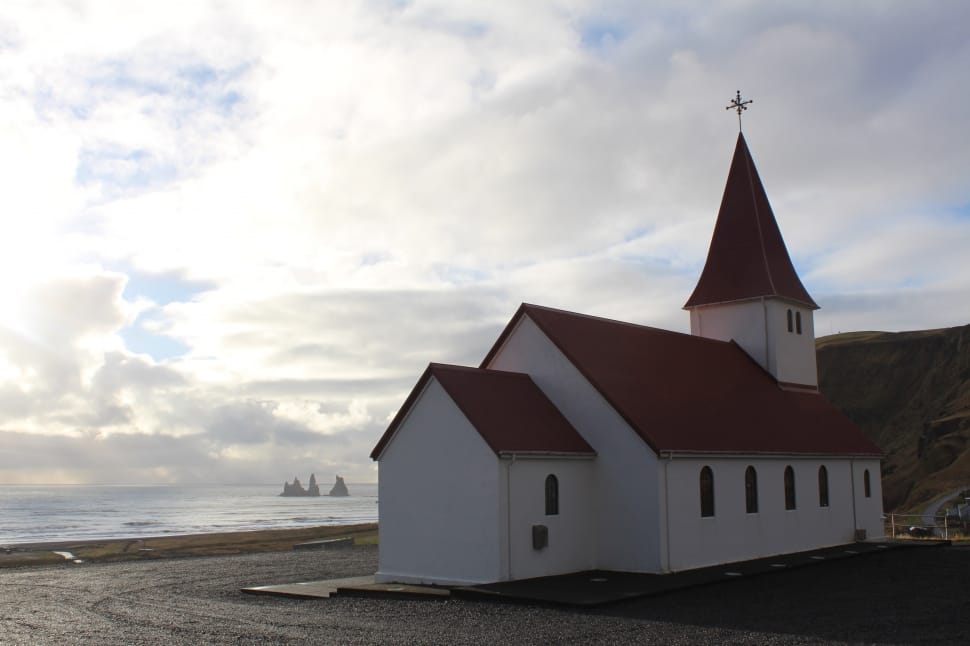 red brick roof and white wooden church preview
