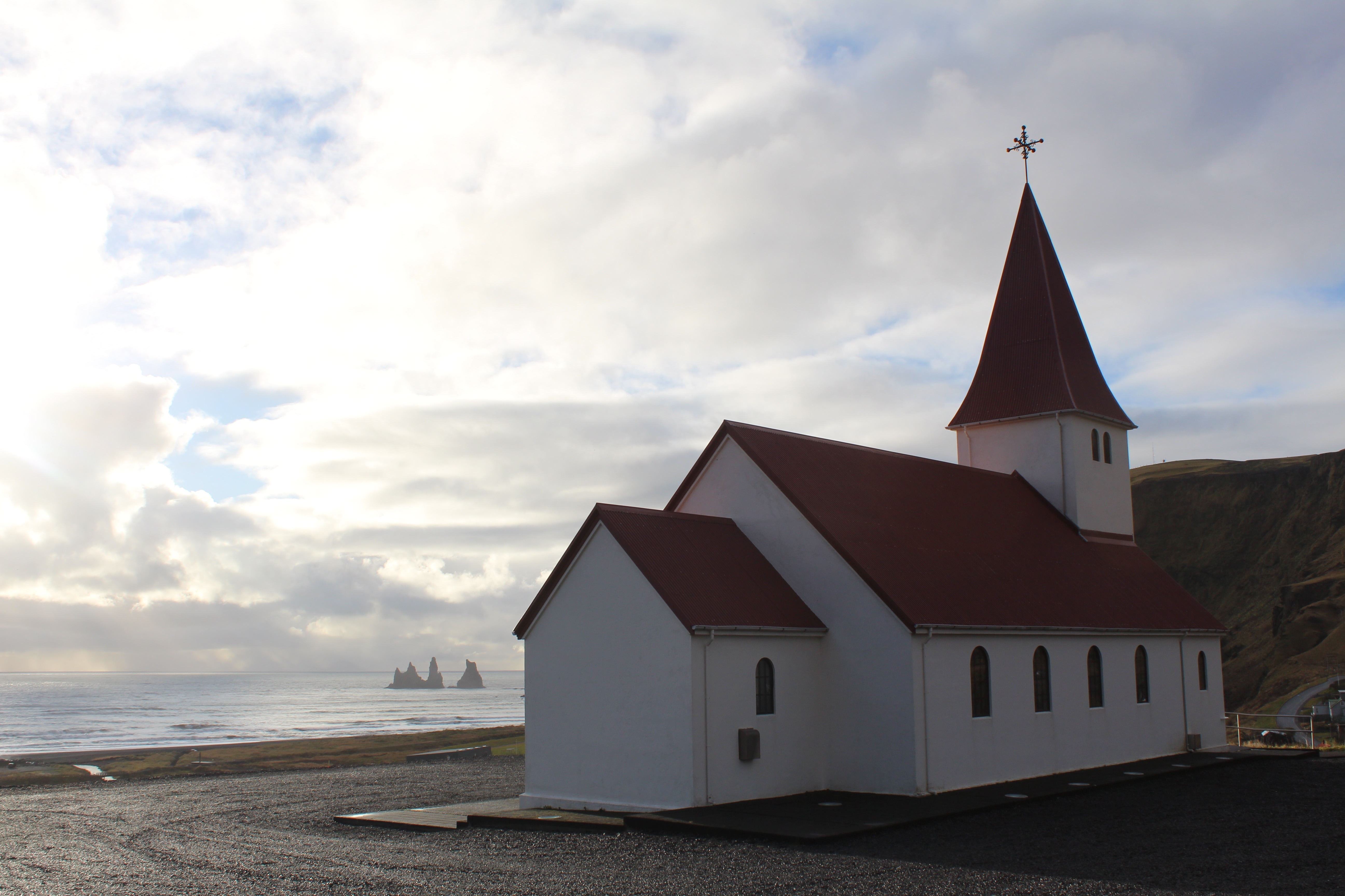 red brick roof and white wooden church