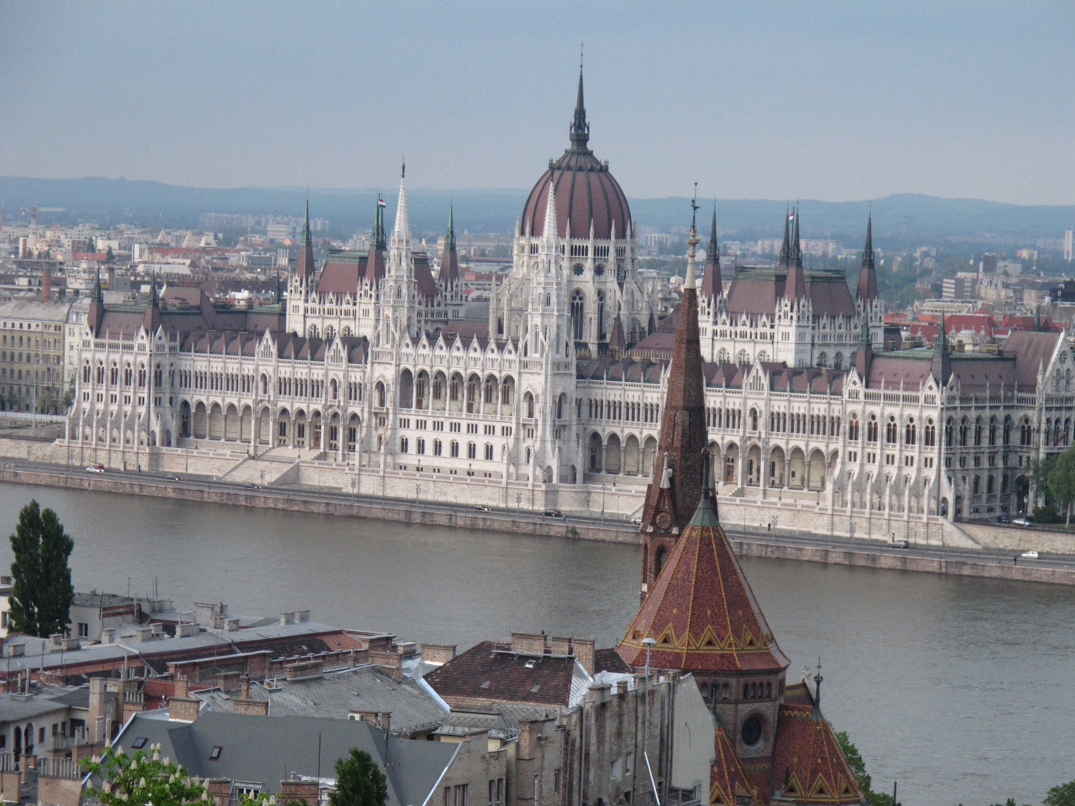 white and brown dome building beside body of water under blue sky during daytime