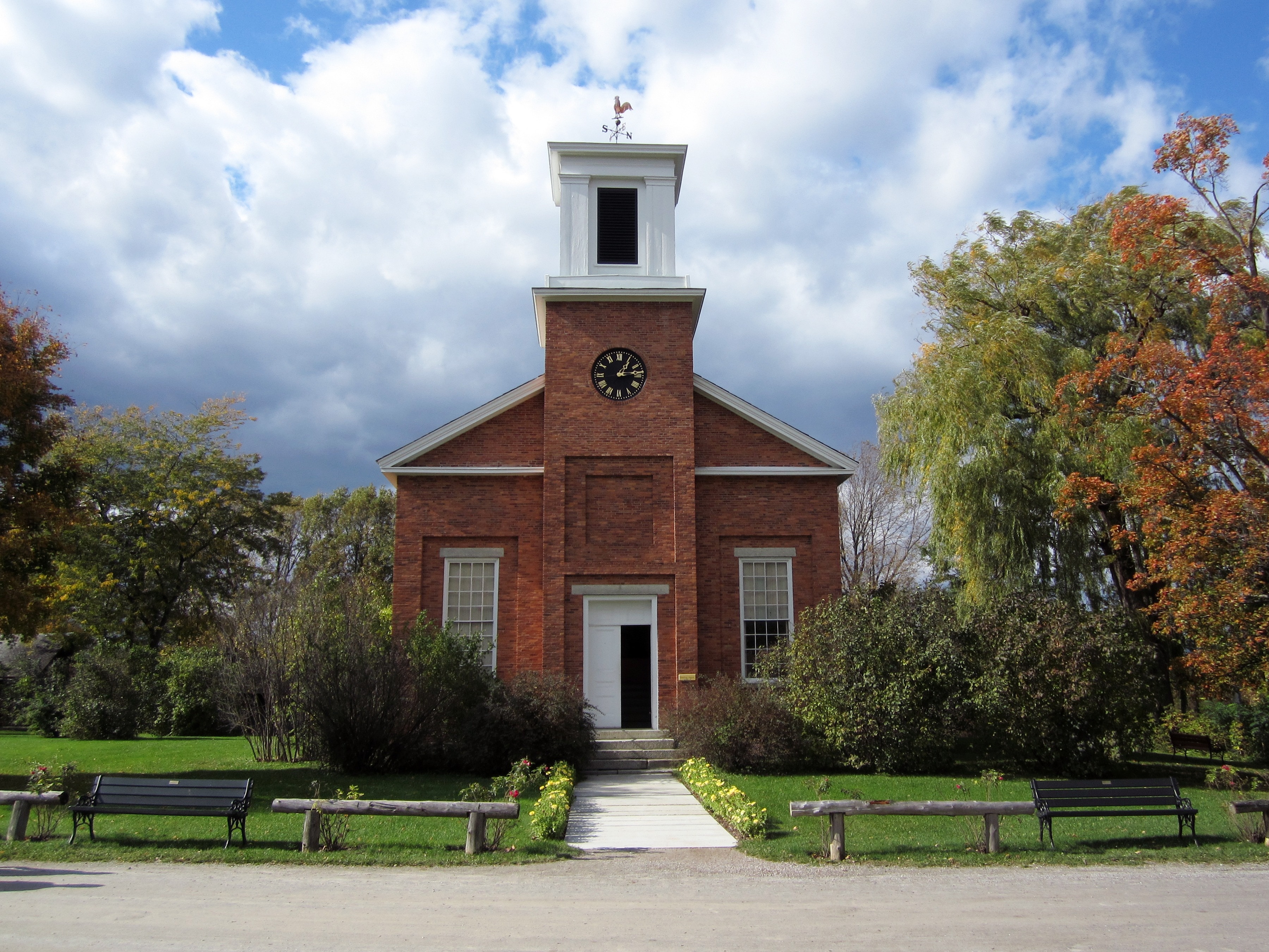 red brick church with bell tower and clock tower