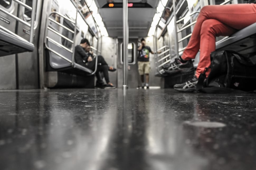 worm's eye view of man standing on train next to a door preview