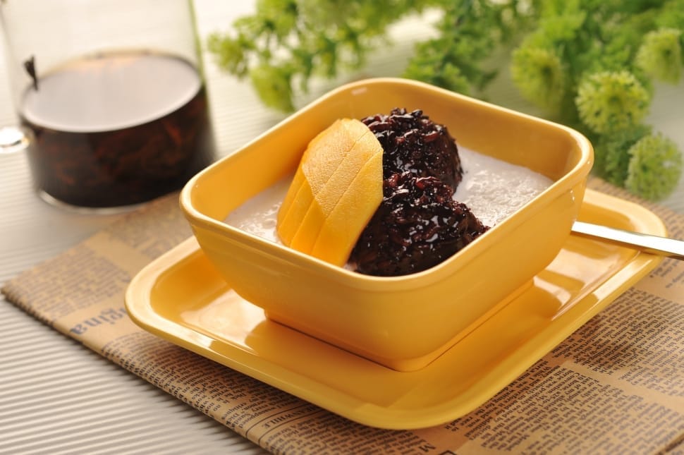 sliced mango on yellow ceramic squared footed bowl preview