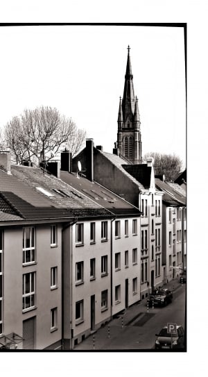 grayscale photo of high rise building and cathedral thumbnail