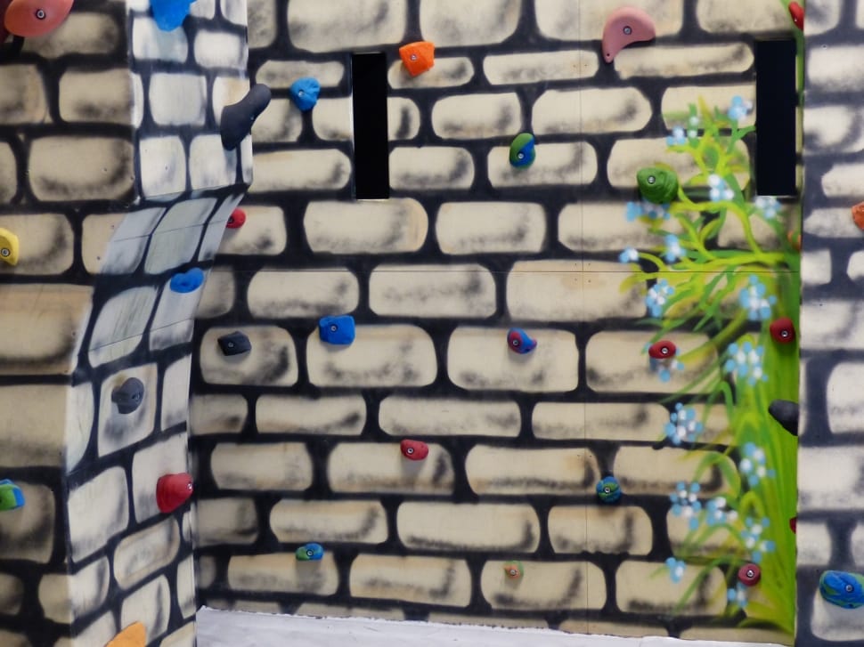 white black green and blue rock climbing wall preview