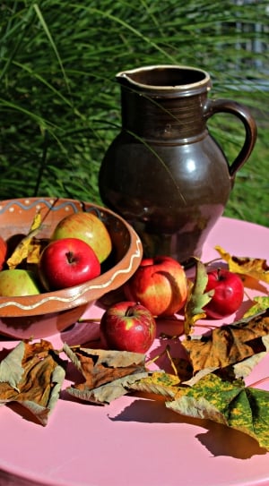black ceramic pitcher and apple fruit thumbnail