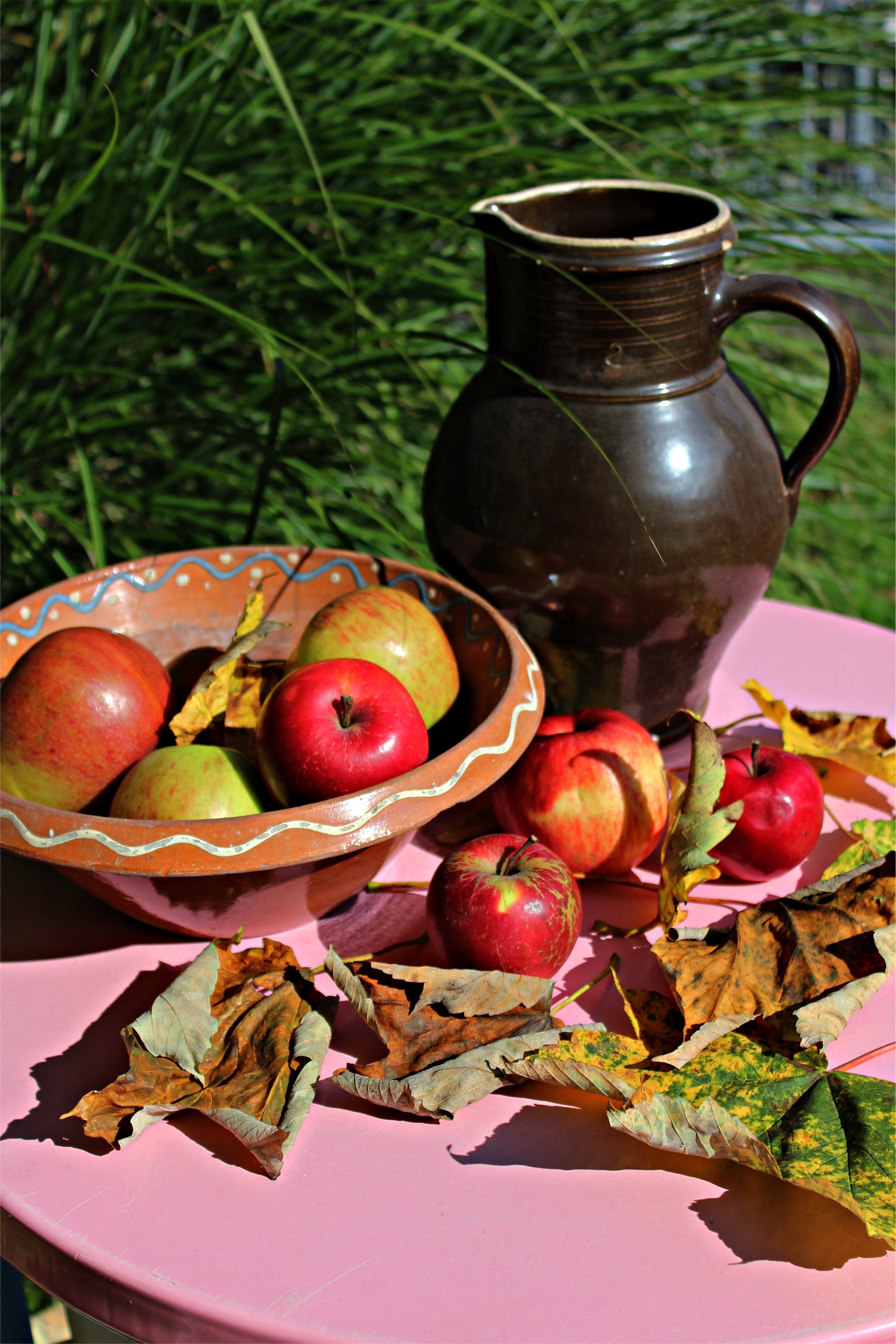 black ceramic pitcher and apple fruit