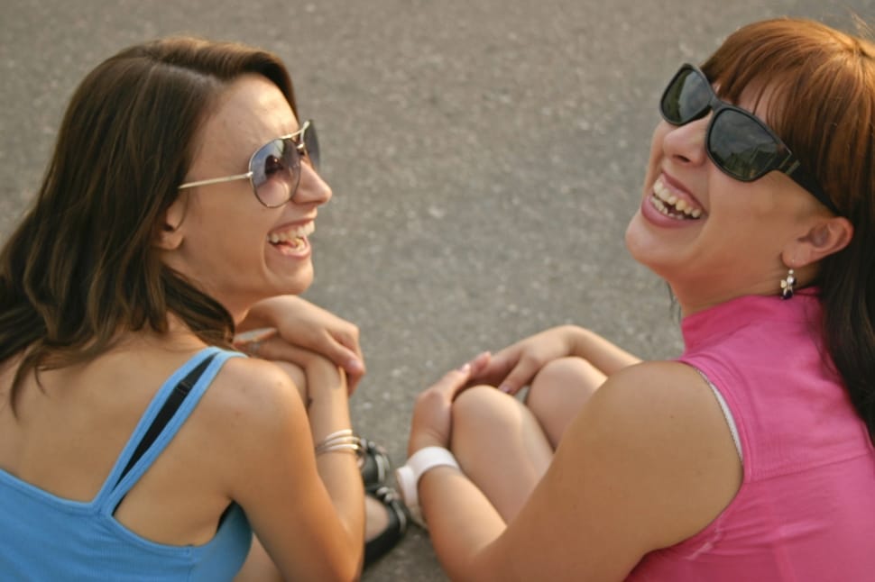 two laughing woman wearing sunglasses preview