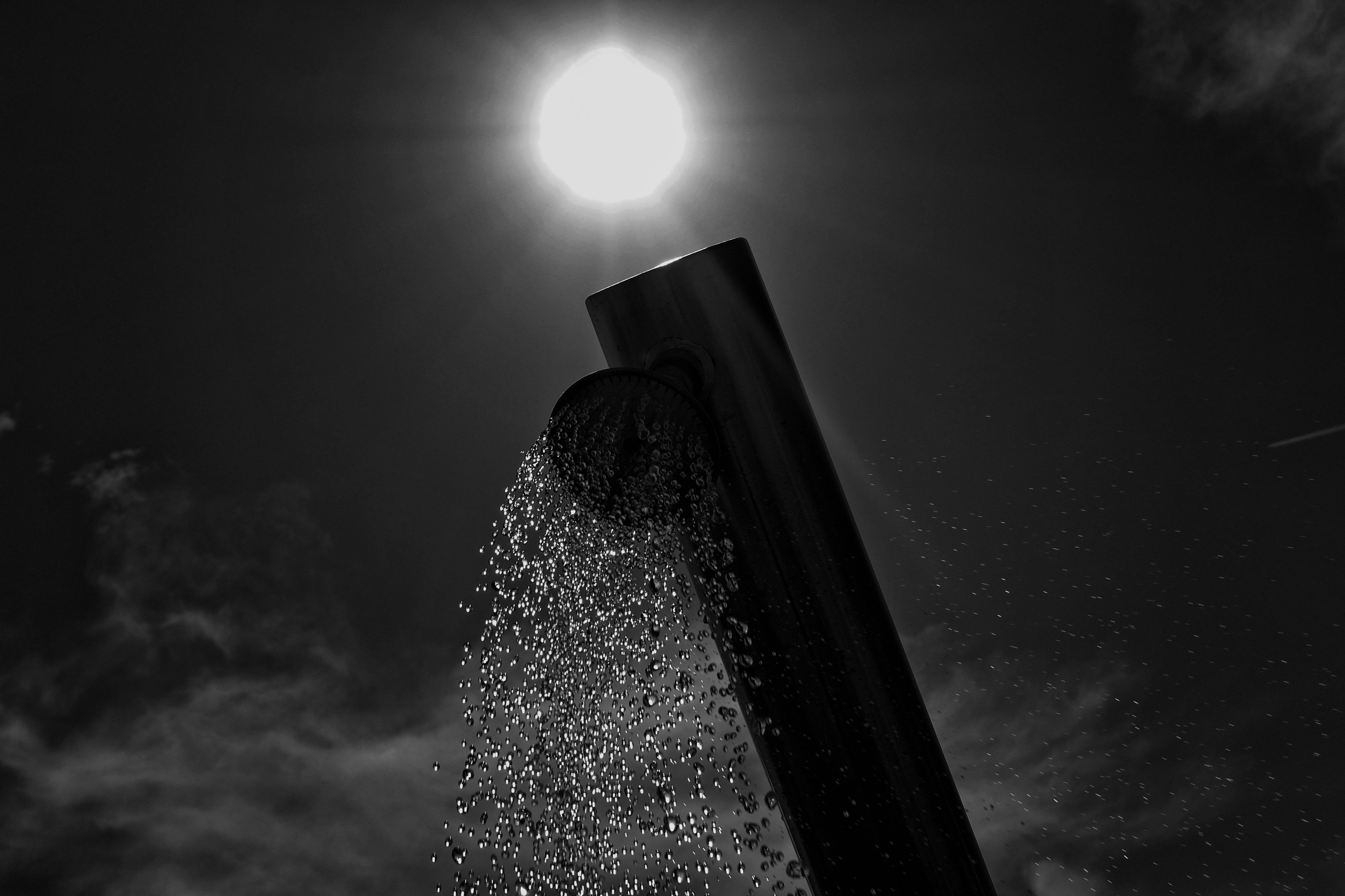 gray scale photo water flowing on rectangular with round attach tool