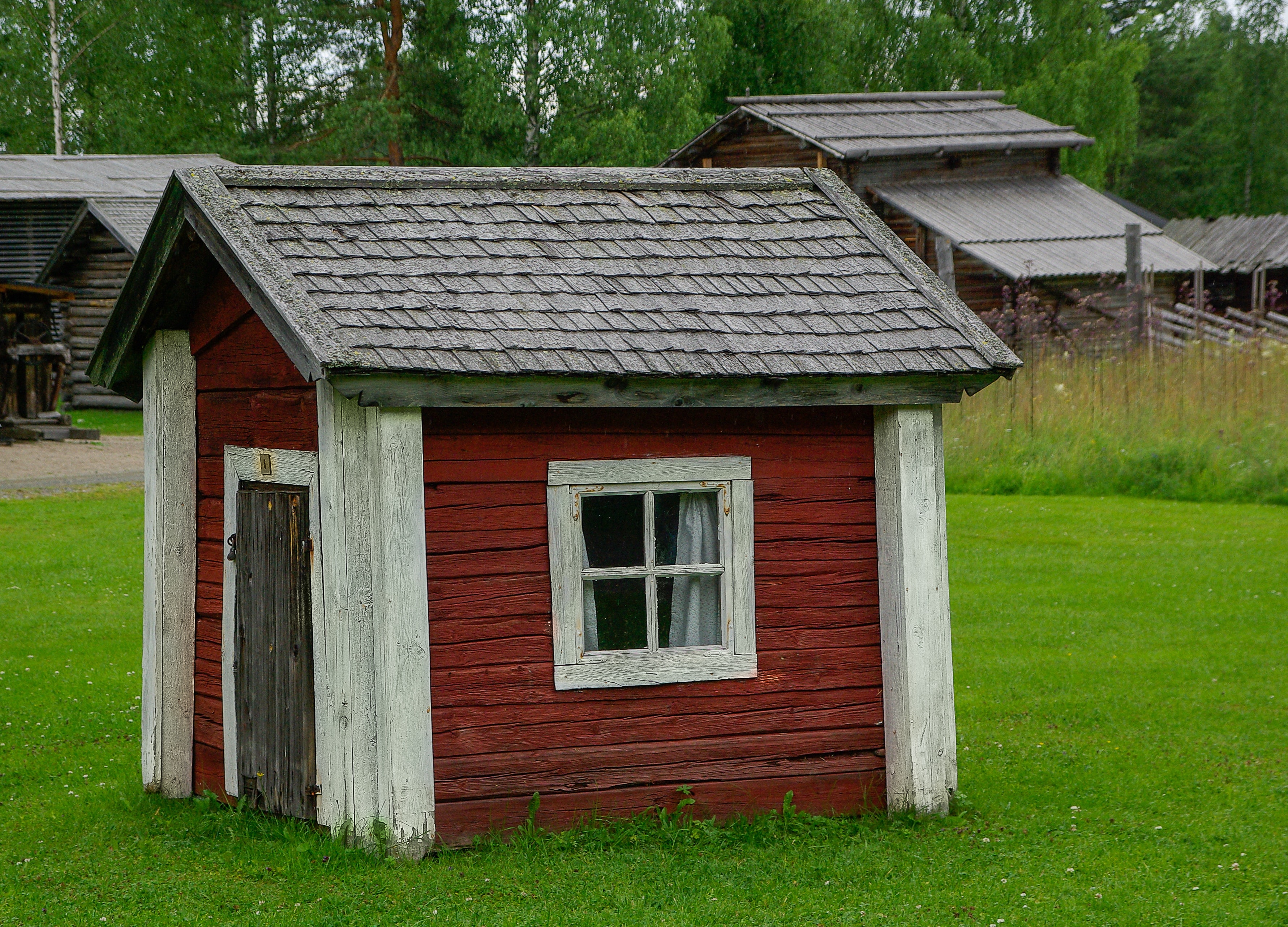 red white and gray wooden storage house