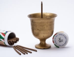 brass goblet with brown stick on the bottle thumbnail