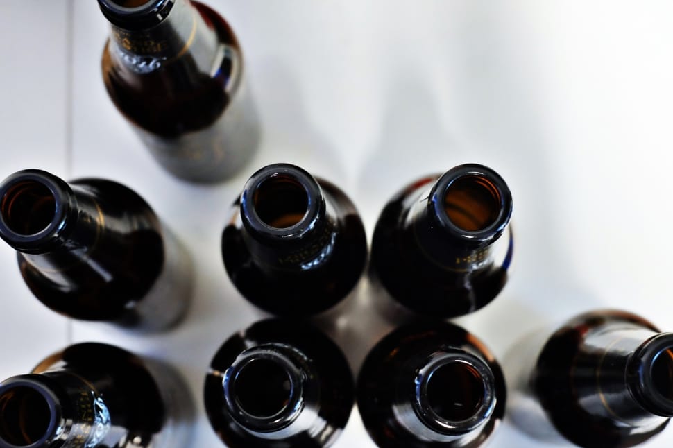 eight brown glass bottles on white surface preview