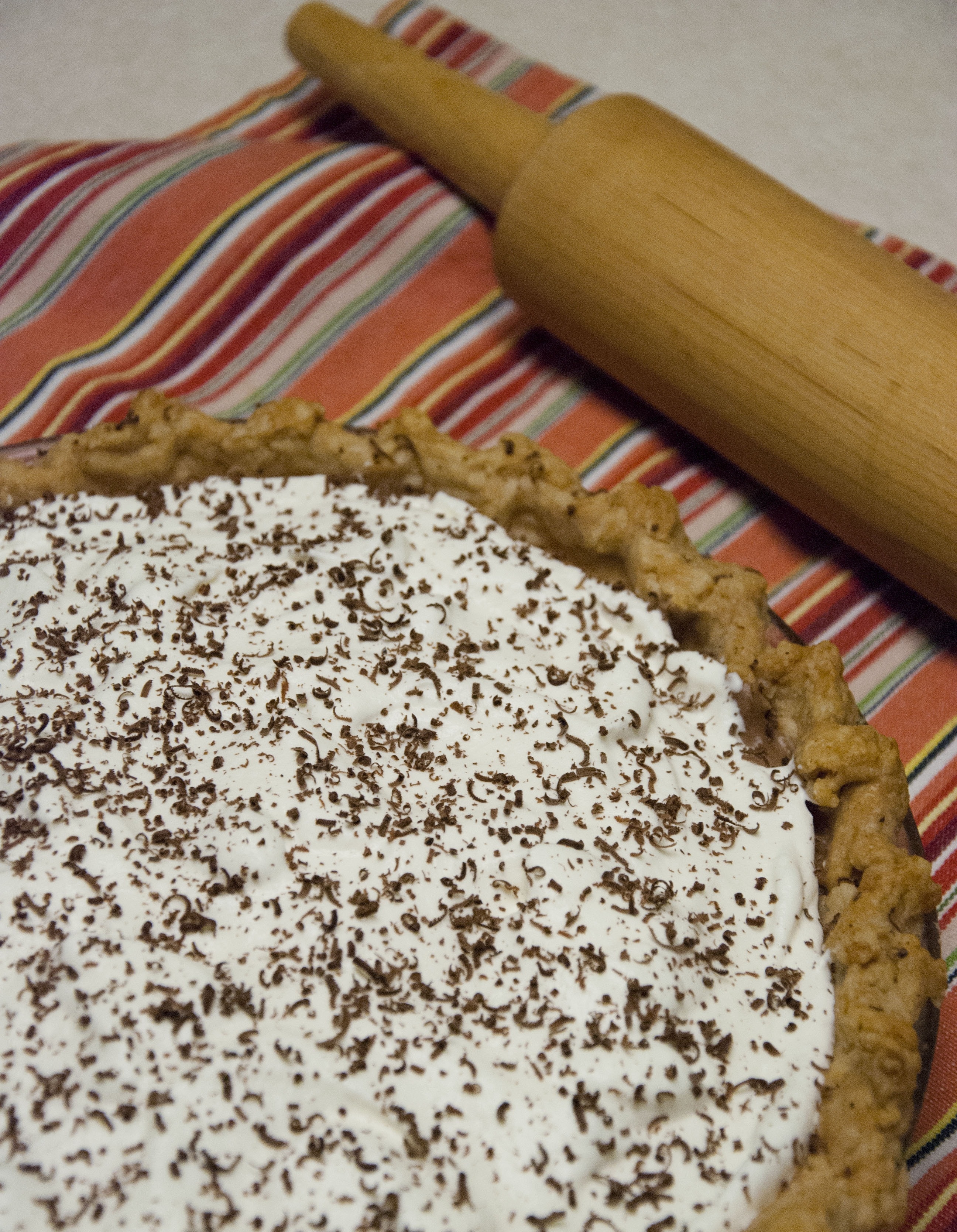creamed pie and brown wooden rolling pin
