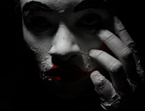 human wearing white makeup and red lipstick thumbnail