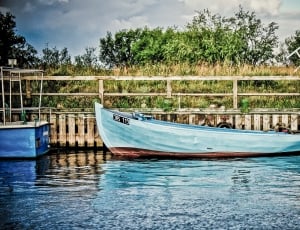 grey canoe near dock during daytime thumbnail