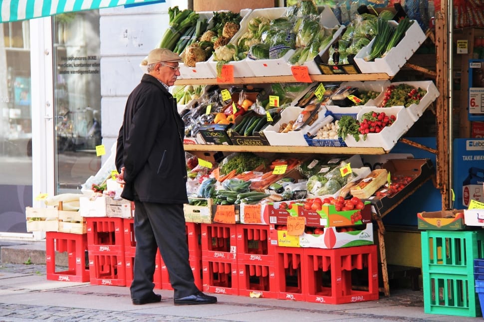 man standing near vegetable display preview