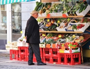man standing near vegetable display thumbnail