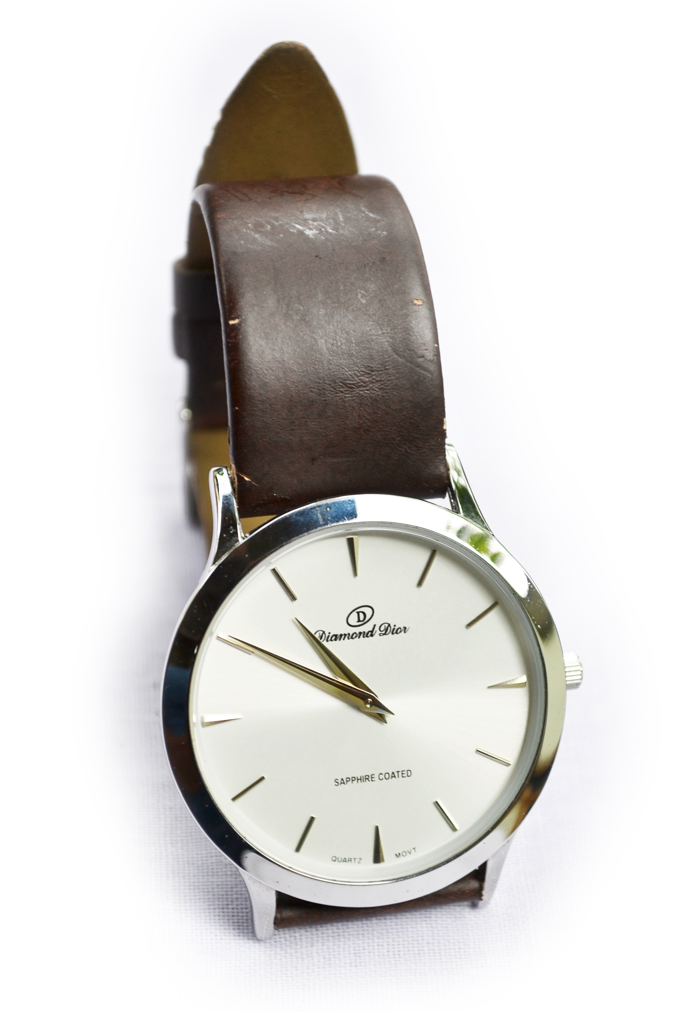 silver round analog watch with black leather strap