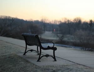 black metal park bench chair beside pathway thumbnail