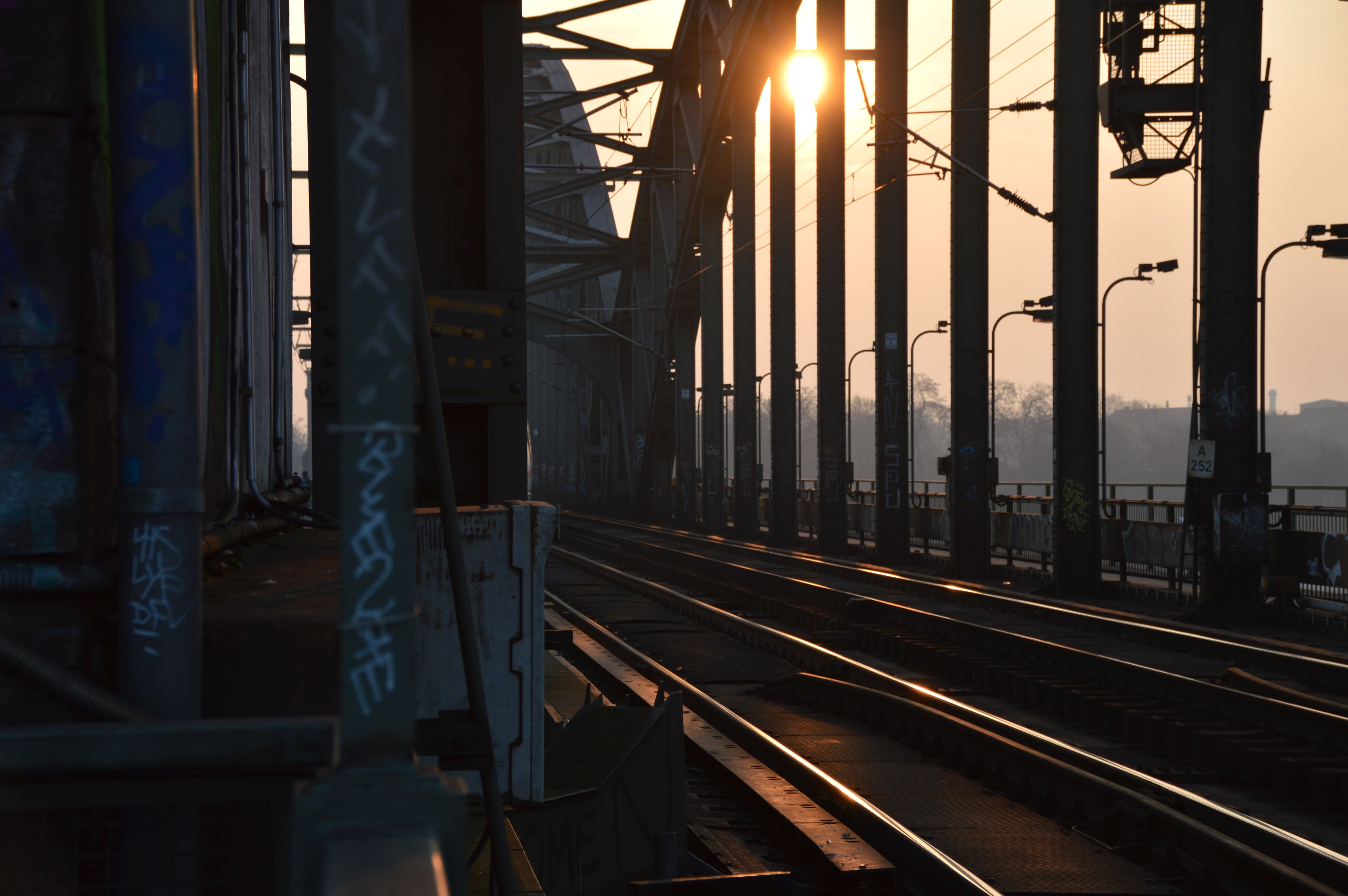silver train rail bridges during daytime