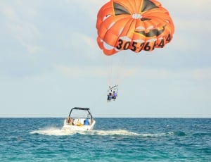 group of people parasailing on ocean thumbnail