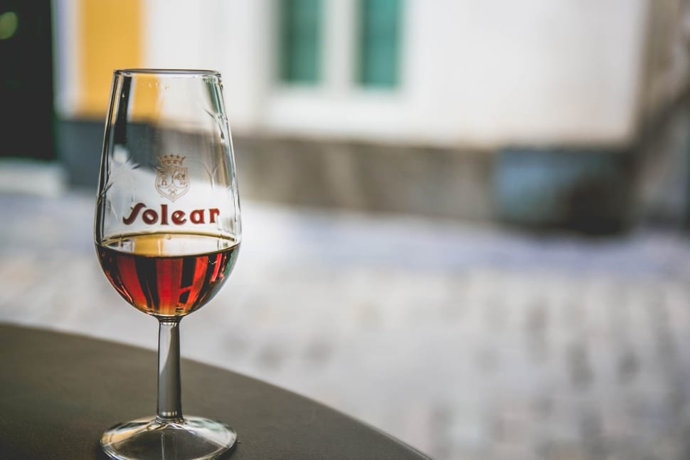 clear  folear wine glass with red liquid inside in macro shot photography preview
