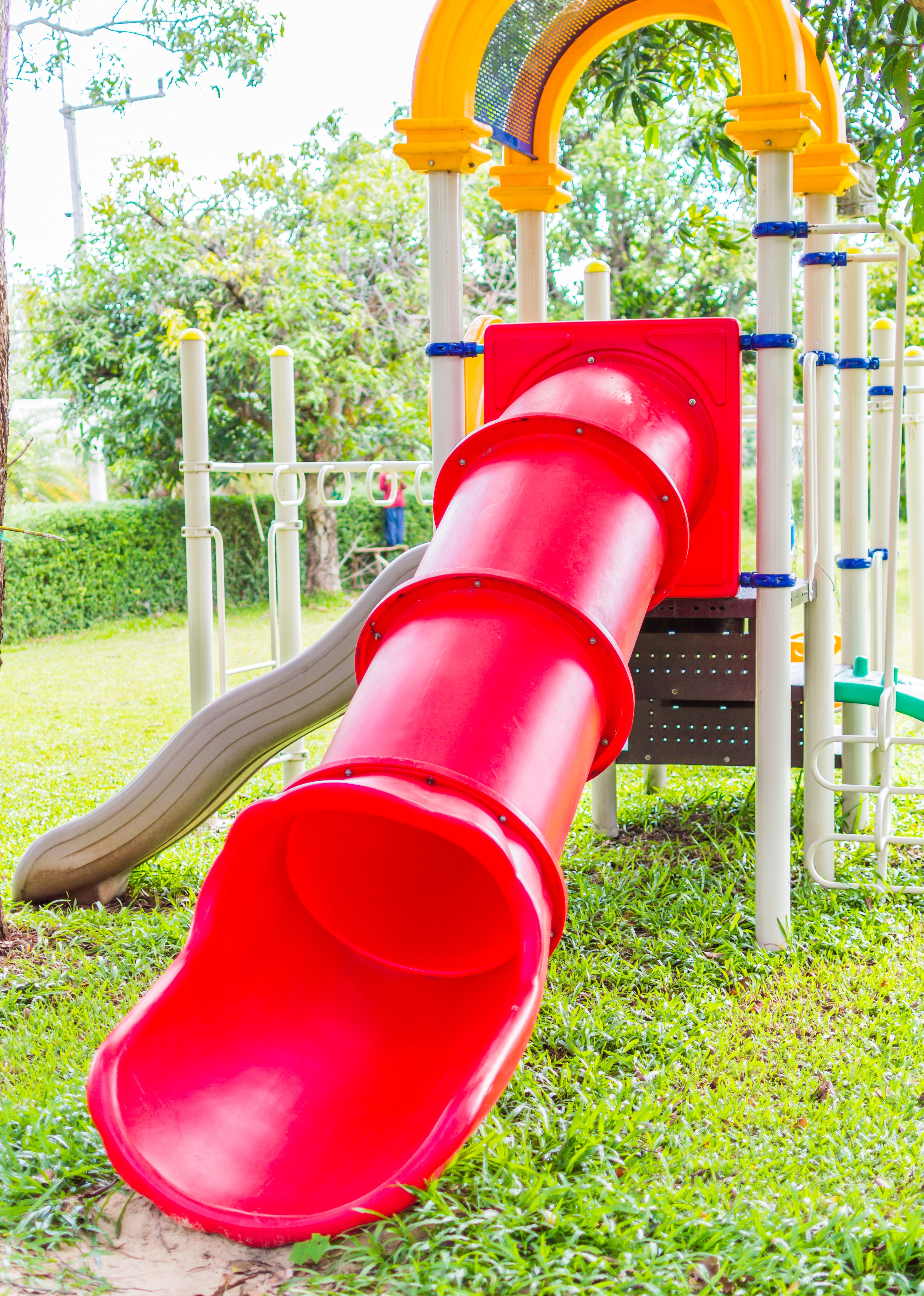 red white and yellow outdoor plastic slides