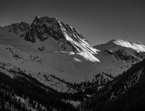 black and white black mountain filled with snow thumbnail