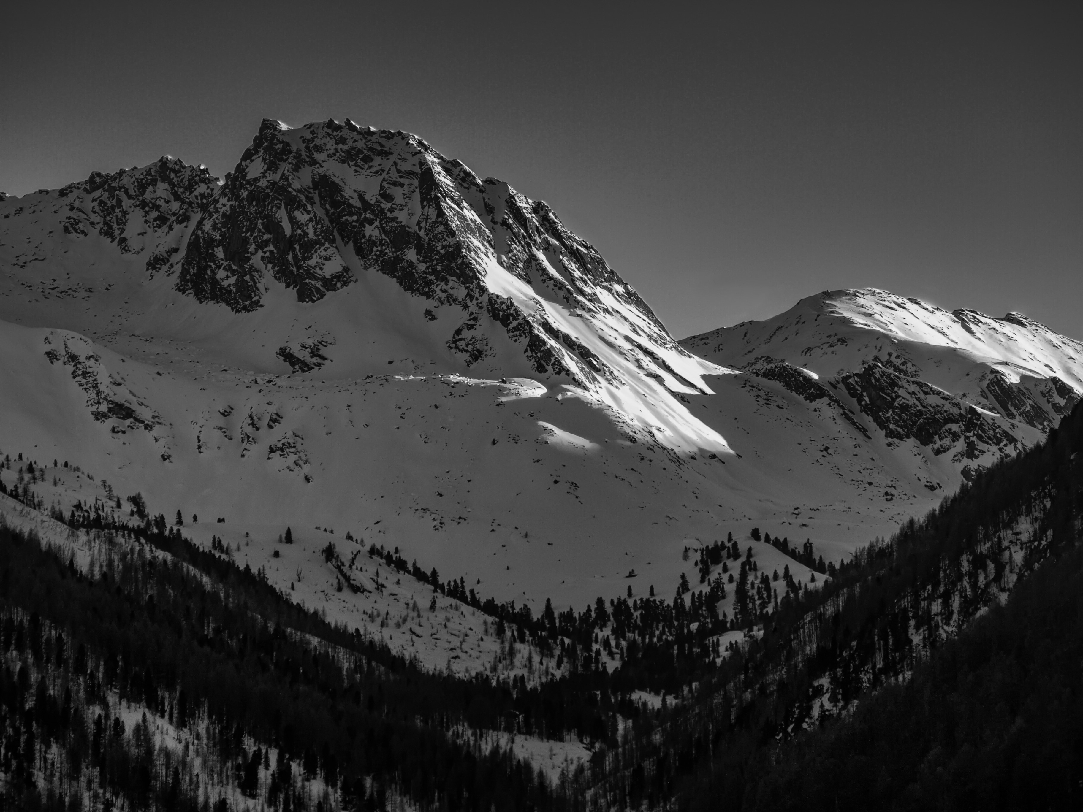 black and white black mountain filled with snow