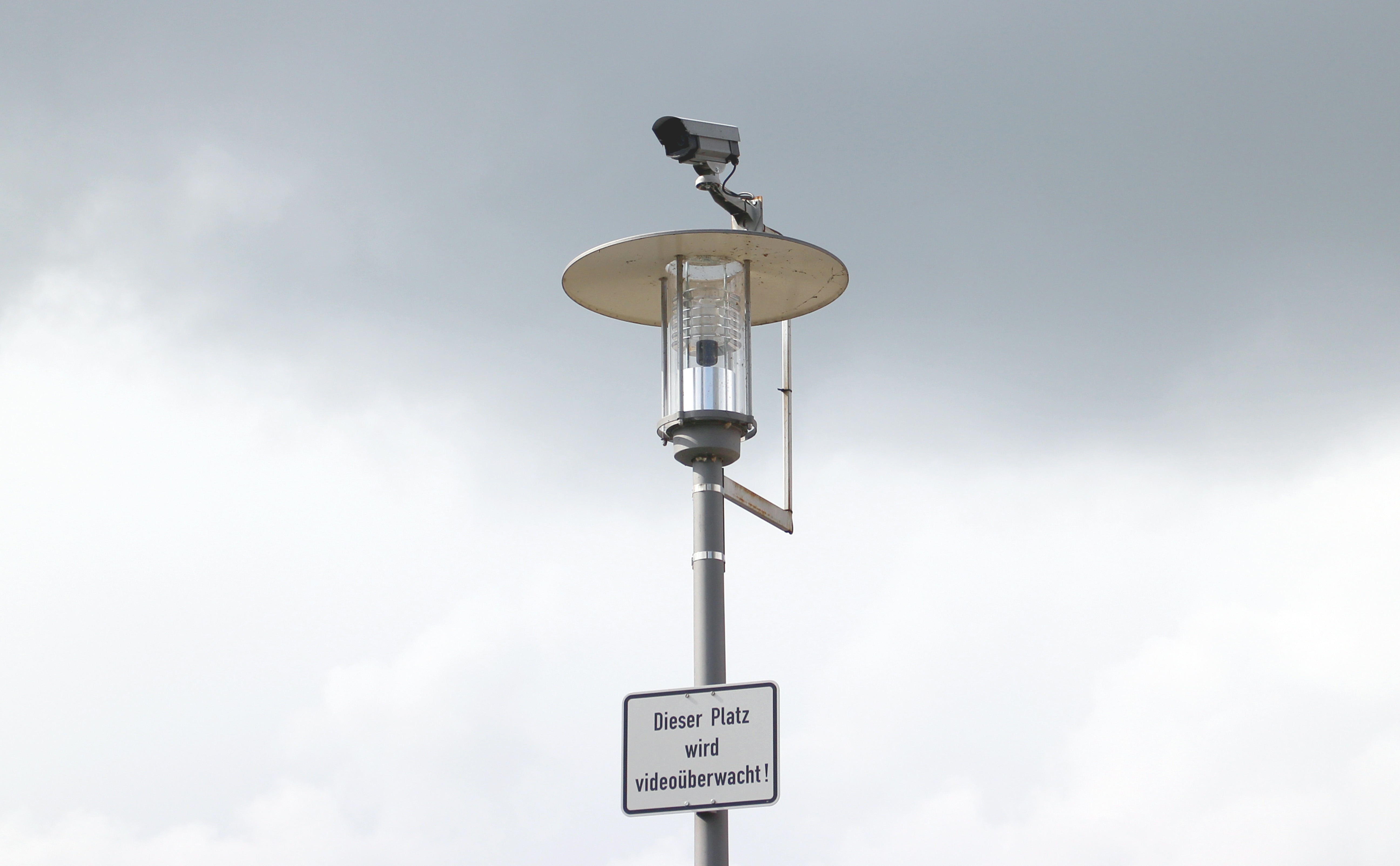 gray-and-beige solar street light with cctv camera