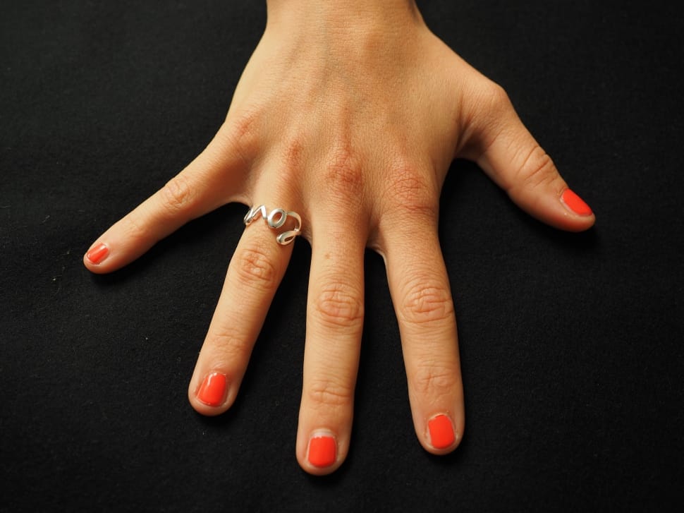 orange nail polish and silver love ring preview