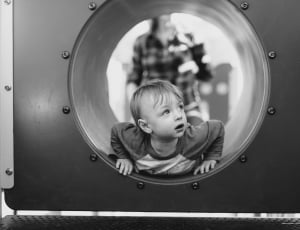 grayscale photo of a boy in tunnel thumbnail