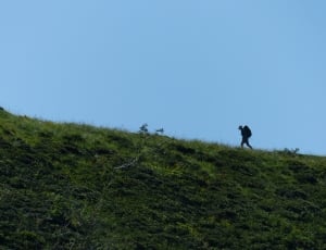 man wearing cap and hiking bag thumbnail