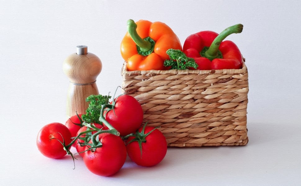 brown wicker basket, six red tomatoes, two orange and red bell peppers preview
