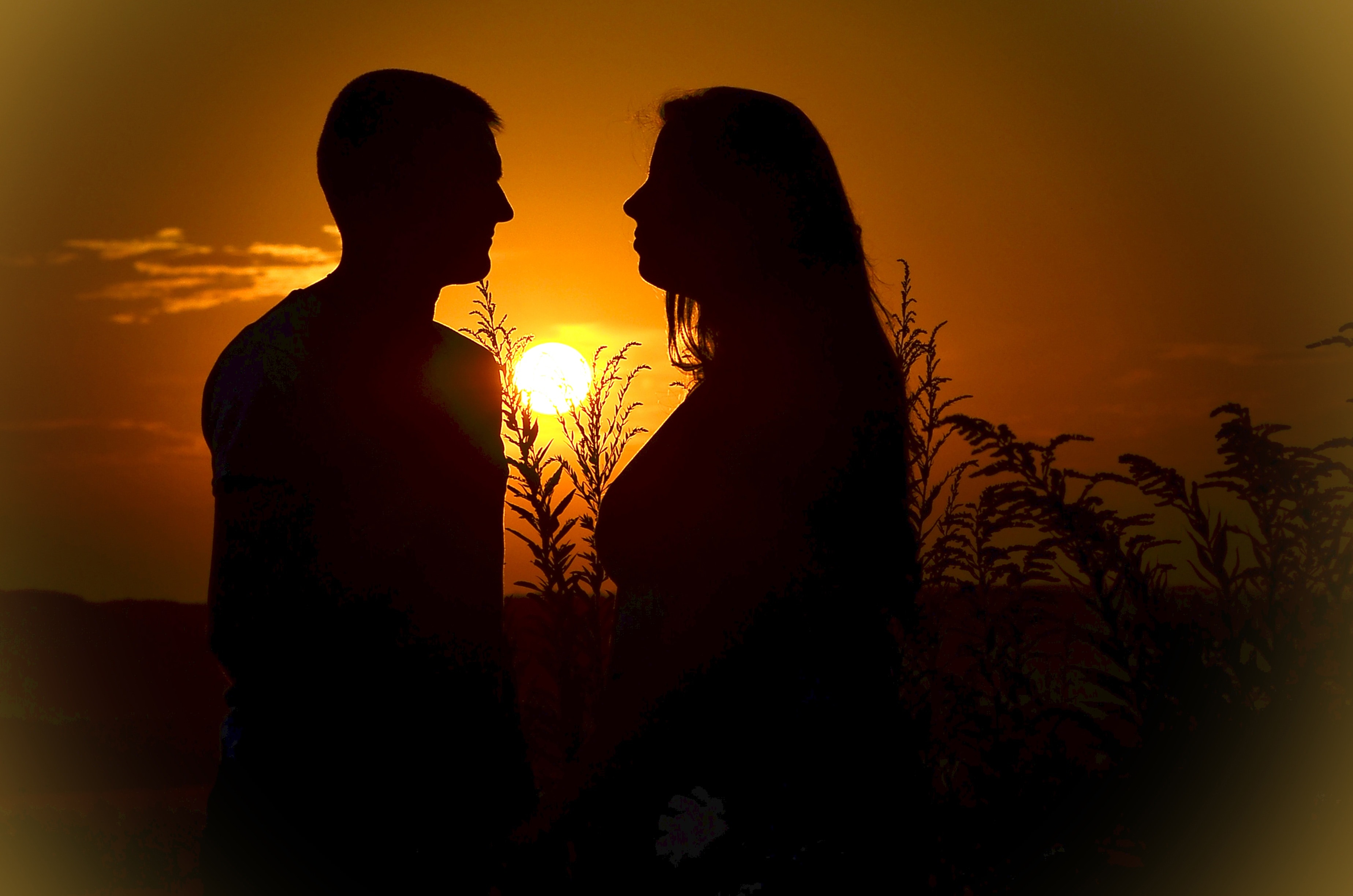 man and woman silhouette photograph