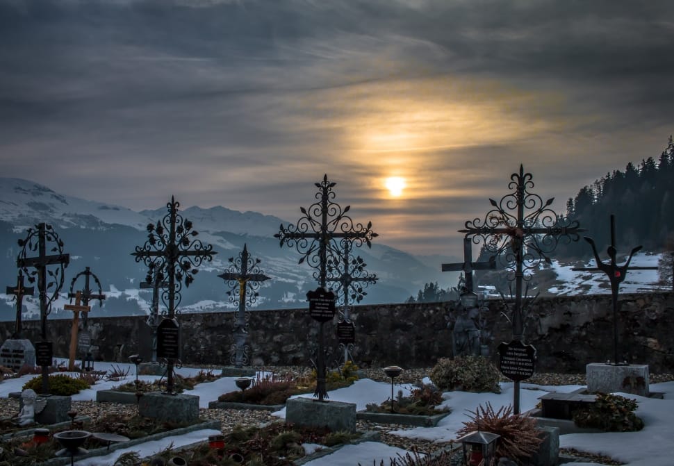 grave near mountain covered with snow during sunset preview