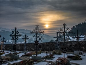 grave near mountain covered with snow during sunset thumbnail